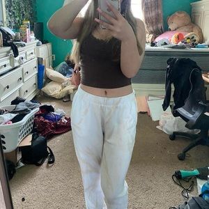 white sweatpants with a cream colored design, barely worn, good condition.